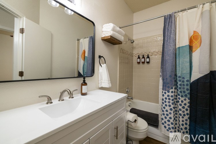 A bathroom with a white sink and a mirror above it.