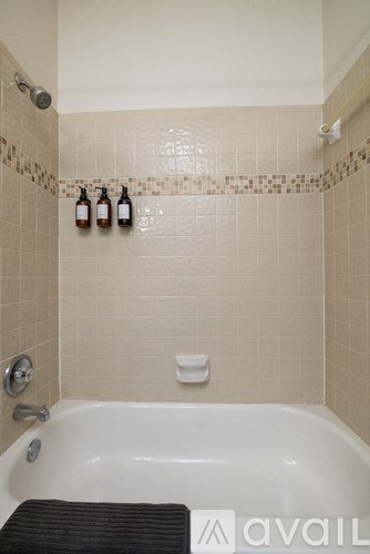 A bathroom with a tub and a shower.