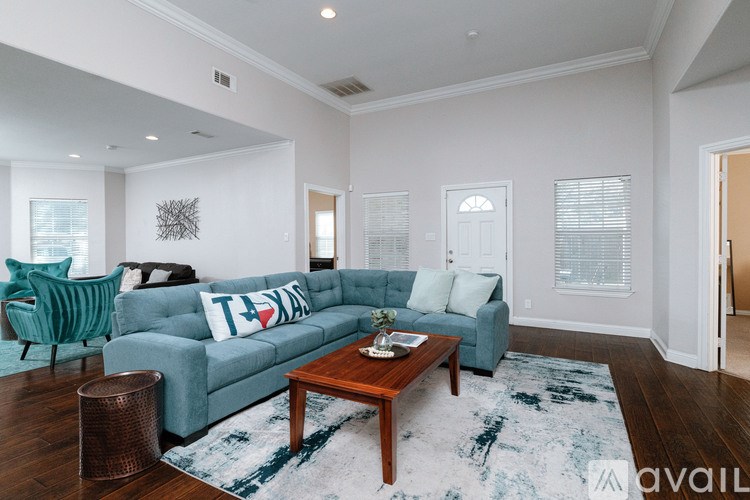 A living room with a blue couch and a wooden coffee table.