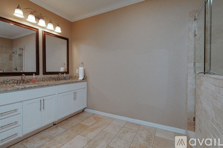 A bathroom with a vanity and a large mirror.
