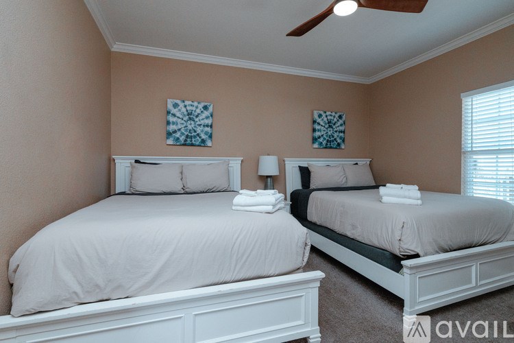 Two twin beds with white headboards and pillows in a room.