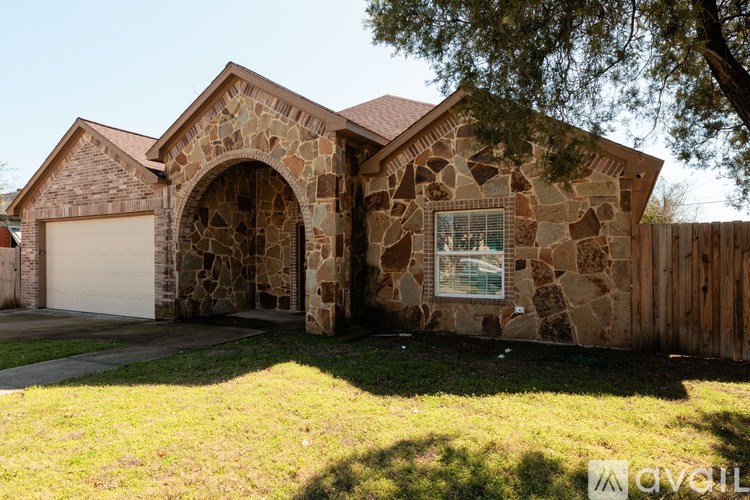 A house with a stone facade and a garage door.