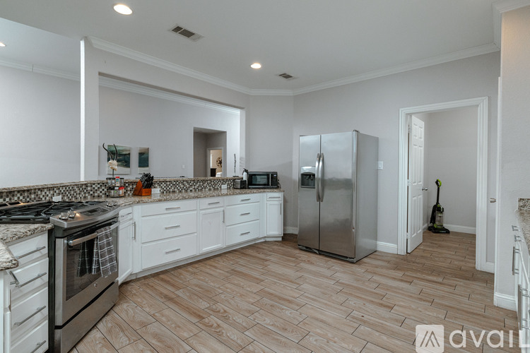 A kitchen with a stove top oven and a refrigerator.