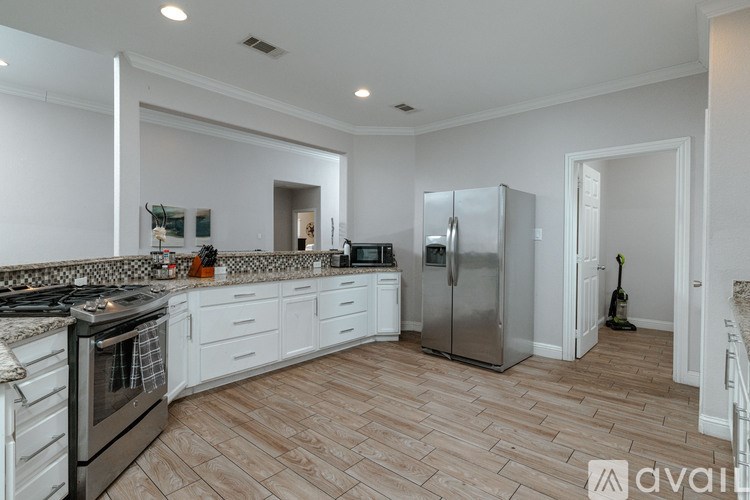 A kitchen with a stove top oven and a refrigerator.