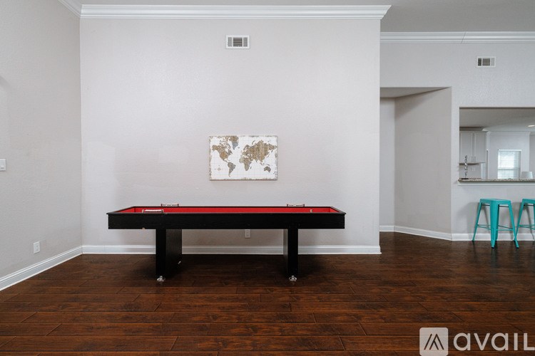 A pool table in a room with a world map on the wall.