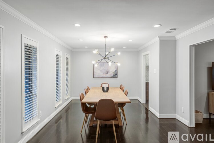 A dining room with a wooden table and chairs.