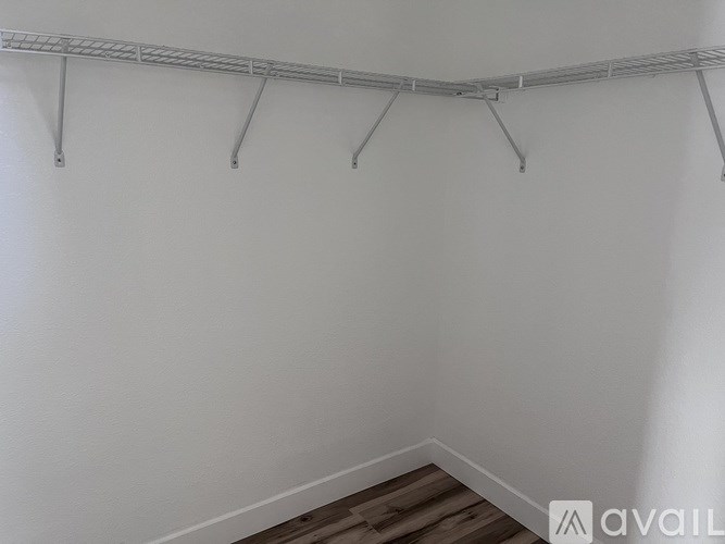 A white wall with a metal rack on it.