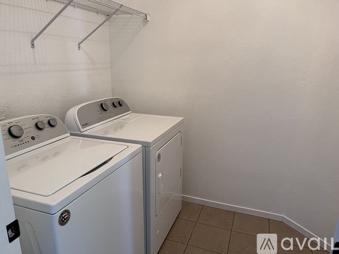 A white washing machine and dryer in a small laundry room.