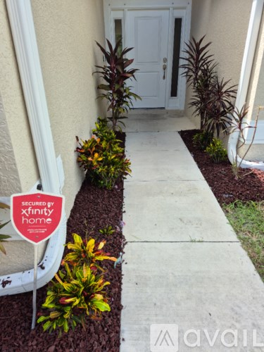 A white door is behind a concrete walkway.