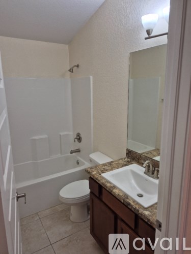A bathroom with a sink, toilet and bathtub.