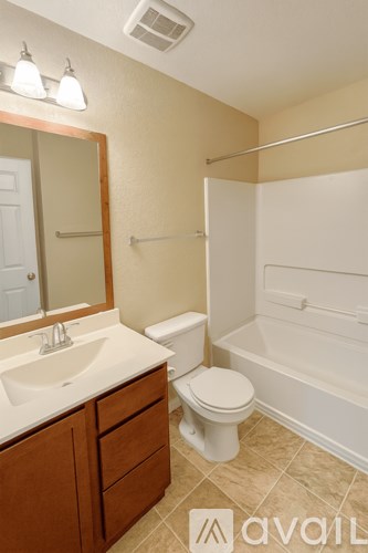 A bathroom with a toilet, sink, and bathtub.