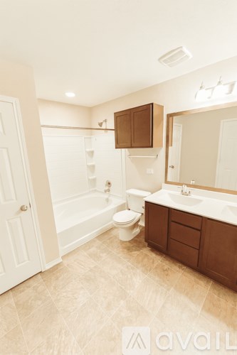 A bathroom with a toilet, sink, and bathtub.