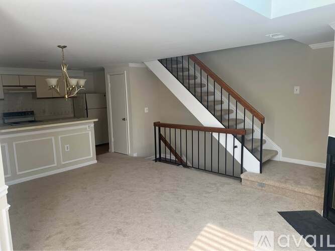 A living room with a staircase leading to the upper floor.