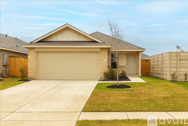 A house with a garage and a driveway in front.