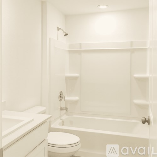 A white bathroom with a toilet, sink, and bathtub.