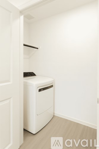 A white washing machine in a small room.