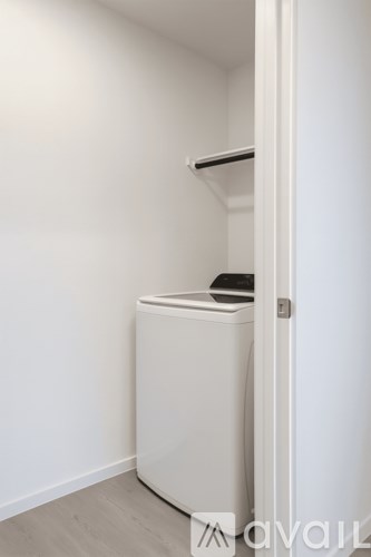 A white dryer is in a small room.