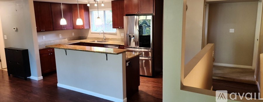 A kitchen with brown cabinets and a white island.