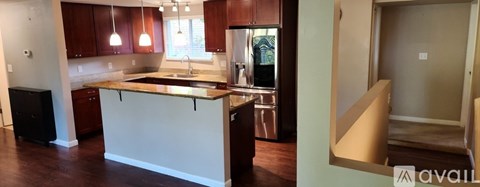 A kitchen with brown cabinets and a white island.