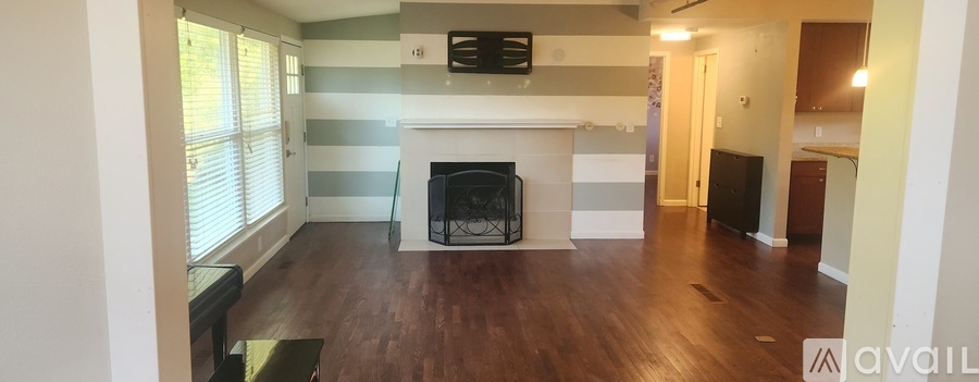A living room with a fireplace and a television.