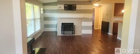 A living room with a fireplace and a television.