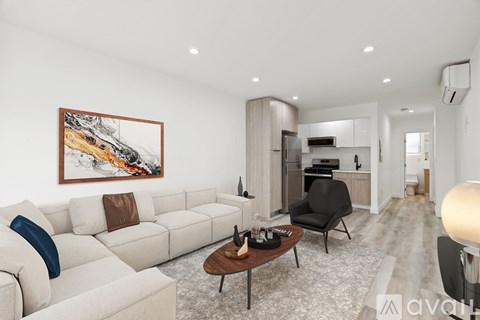 A modern living room with a large painting on the wall and a white sofa.