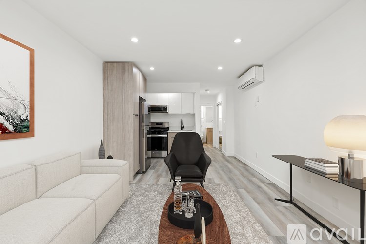 A modern living room with a white sofa, a black chair, and a wooden coffee table.