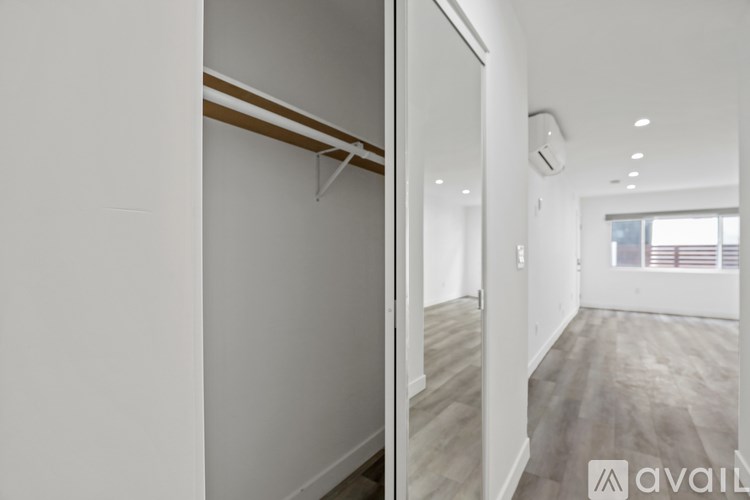 A room with a white wall and a wooden floor.