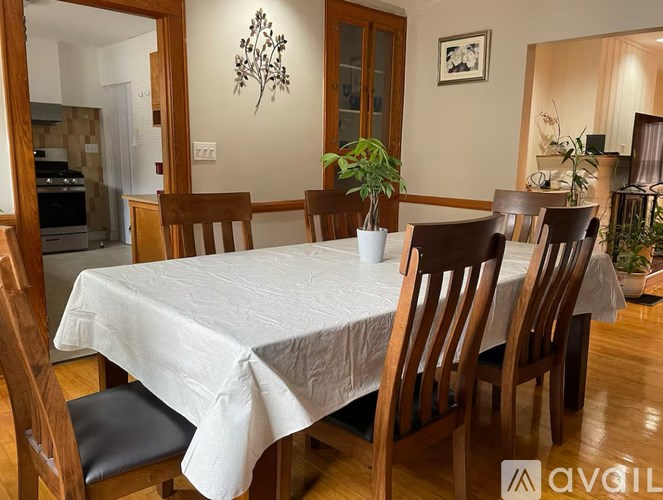 A dining room with a table and chairs.