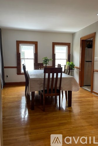 A dining room with a table and chairs.