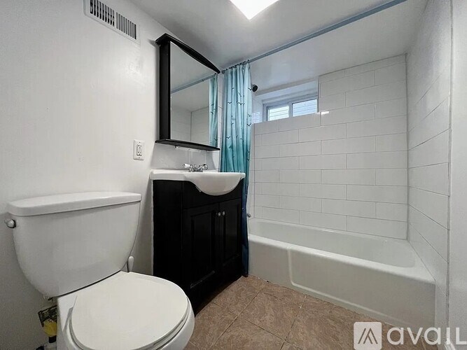 A bathroom with a white toilet, a sink, and a bathtub.