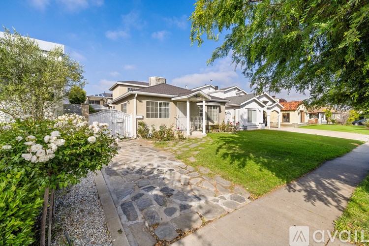 A house with a stone pathway leading to the front door.