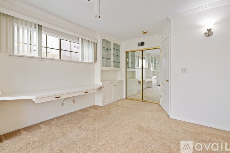 A room with a window, a bench, and a door.