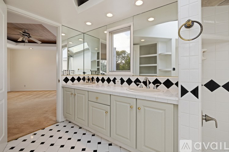 A bathroom with a black and white checkered floor.
