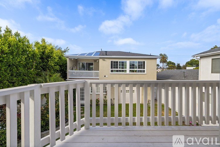 A house with a white fence in front of it.