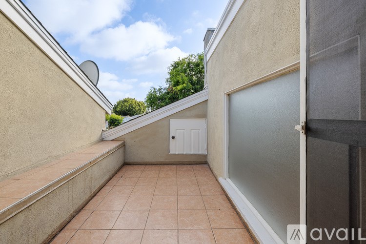 A balcony with a door and a window.