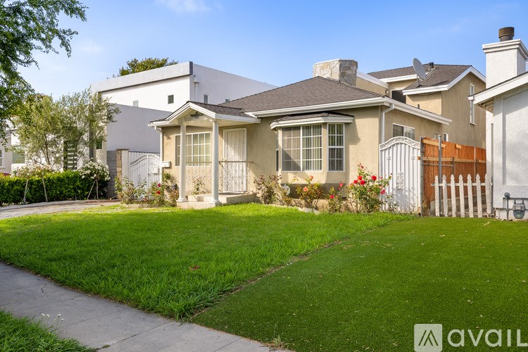 A house with a well-maintained lawn in front.