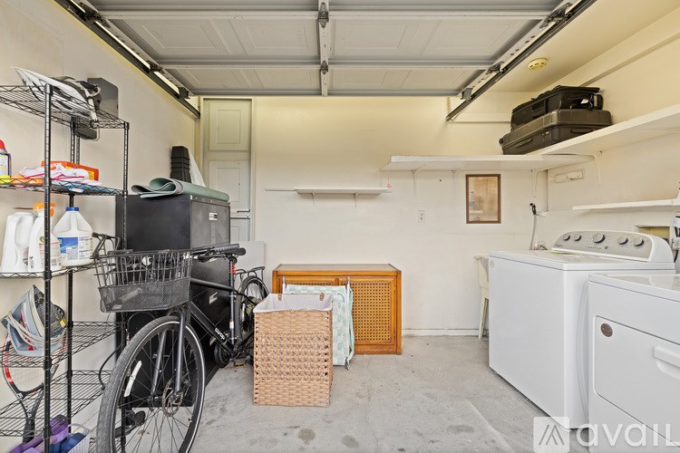 A room with a bicycle, a basket, and a white oven.