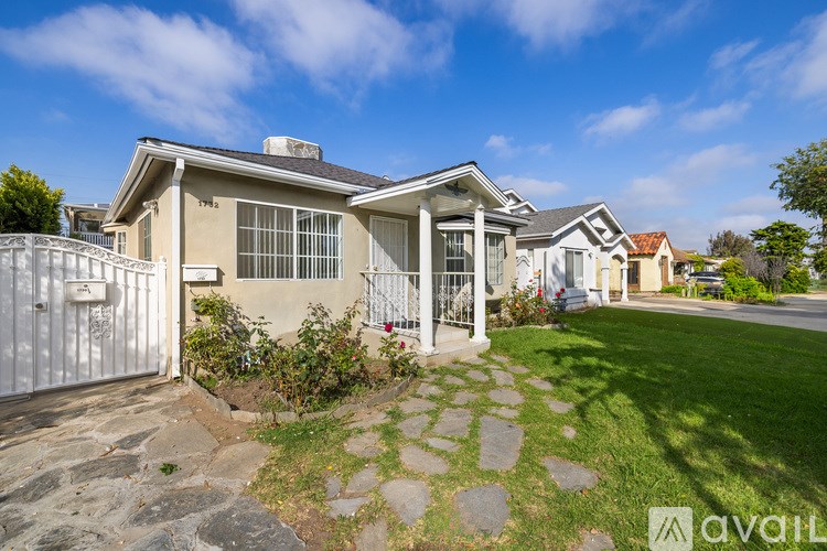 A house with a stone pathway leading to the front door.