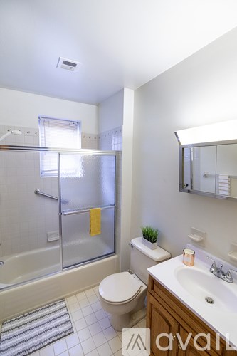A bathroom with a toilet, sink, and shower.