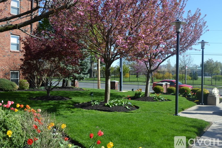 A beautifully landscaped garden with a variety of flowers and trees.