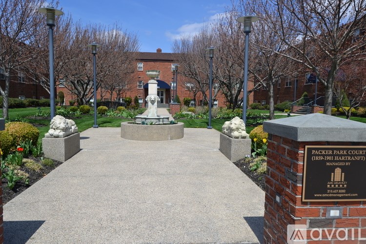 A brick building with a statue in front of it.