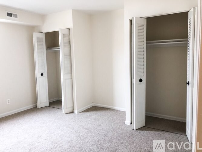 A kitchen with a stove, sink, and cabinets.