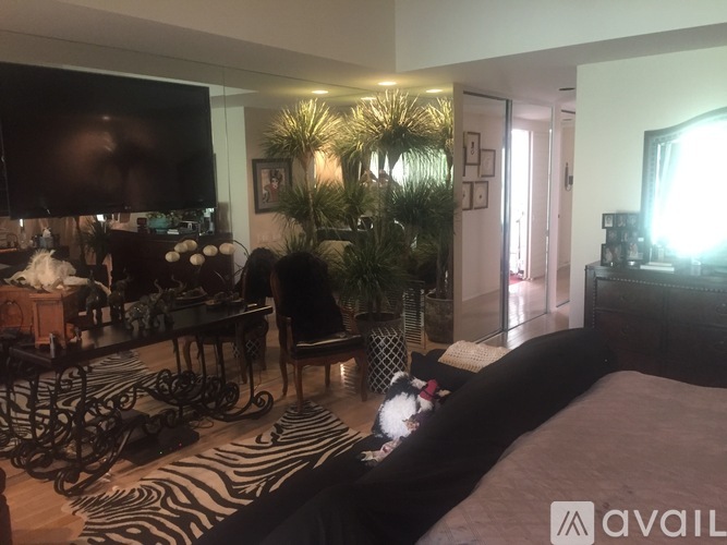 A bedroom with a zebra print rug and a large bed.
