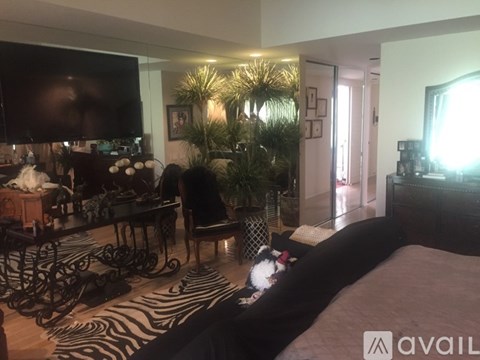 A bedroom with a zebra print rug and a large bed.