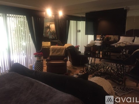 A living room with a couch, chair, and television.