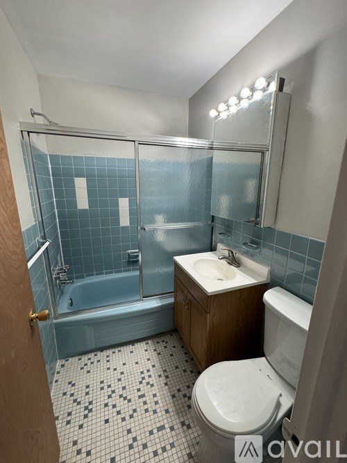 A bathroom with a toilet, sink, and shower.