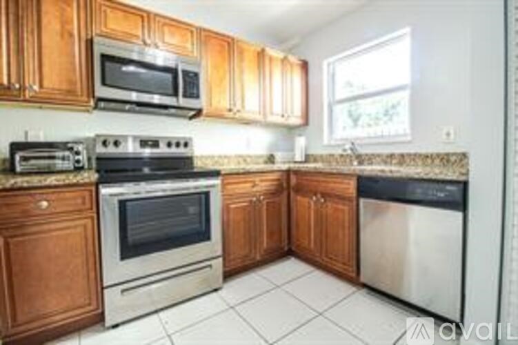 A kitchen with wooden cabinets and stainless steel appliances.