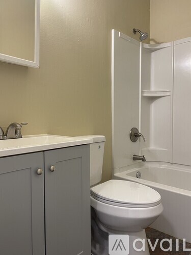 A bathroom with a toilet, sink, and bathtub.