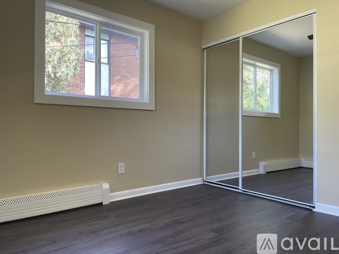 A room with a large mirror and a window.